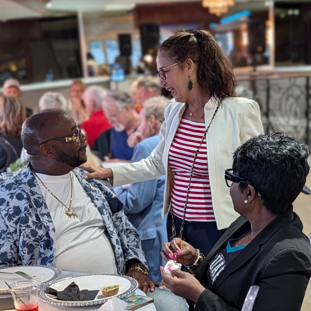 Event Host Lezlee Visits with Passengers